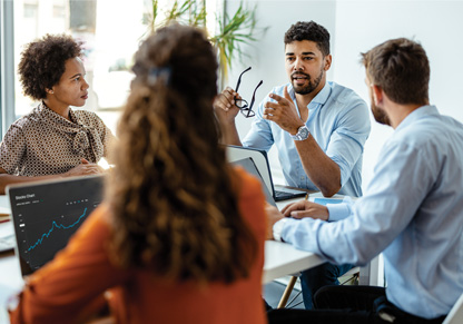 Four people talking around a table