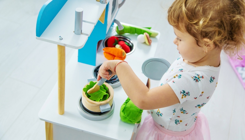 the child plays in the kitchen and cooks