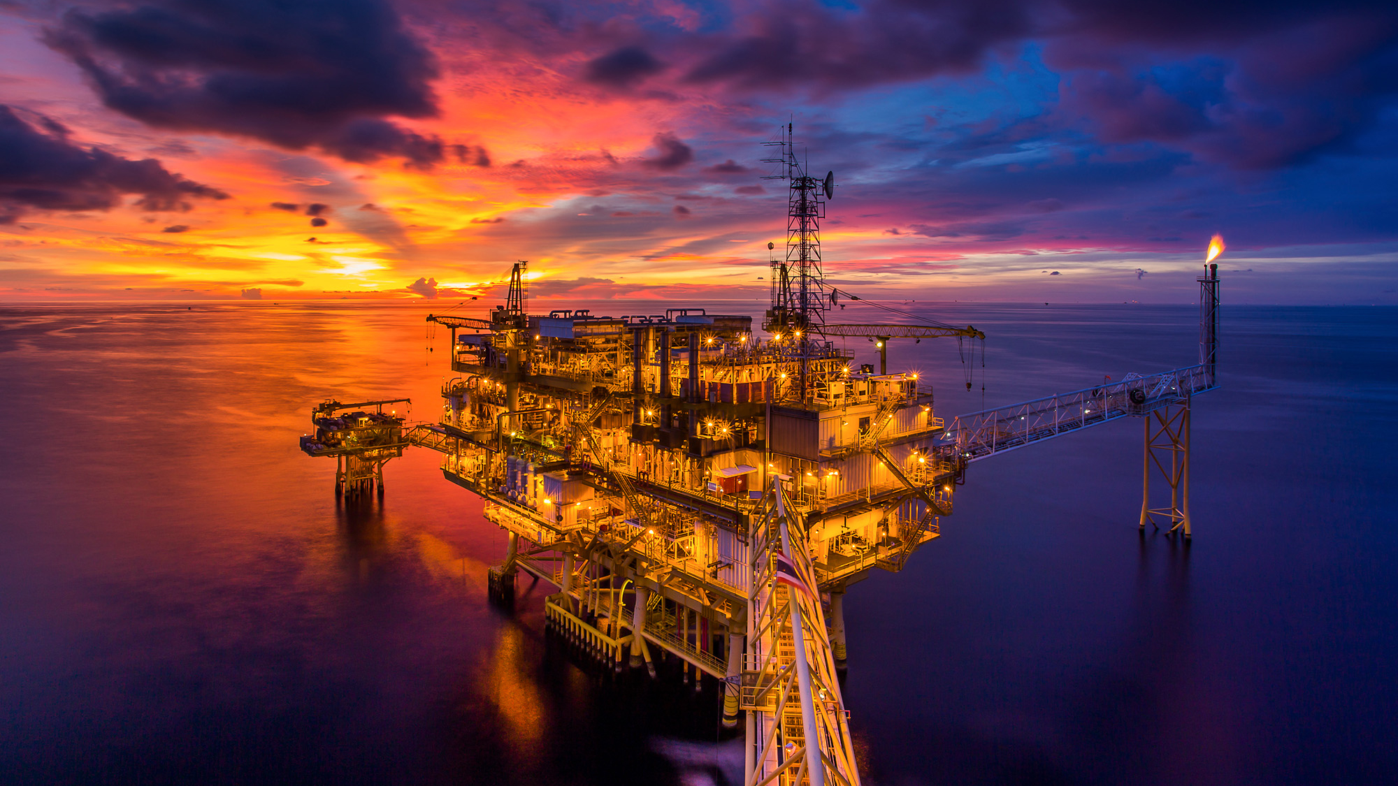  Oil platform at sea, lit up, at dusk