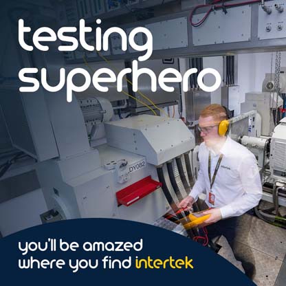 Technician with ear protection standing next to large machine with metering device