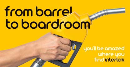 A hand grasping a yellow gas pump nozzle