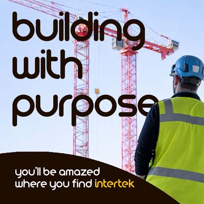 A construction engineer looking at a pair of building cranes